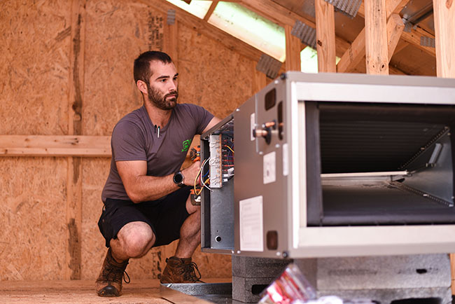 Brothers Heating and Air professional in an attic